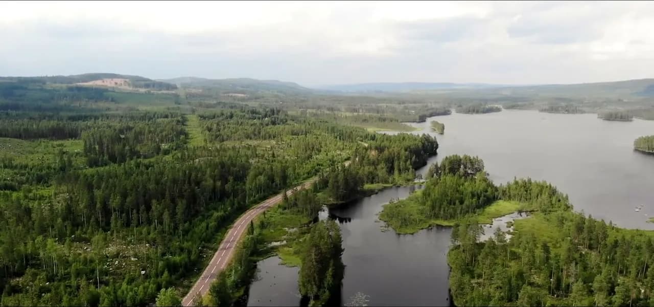 Aerial view of Finnish Lapland — endless forest, lakes and a lone road
