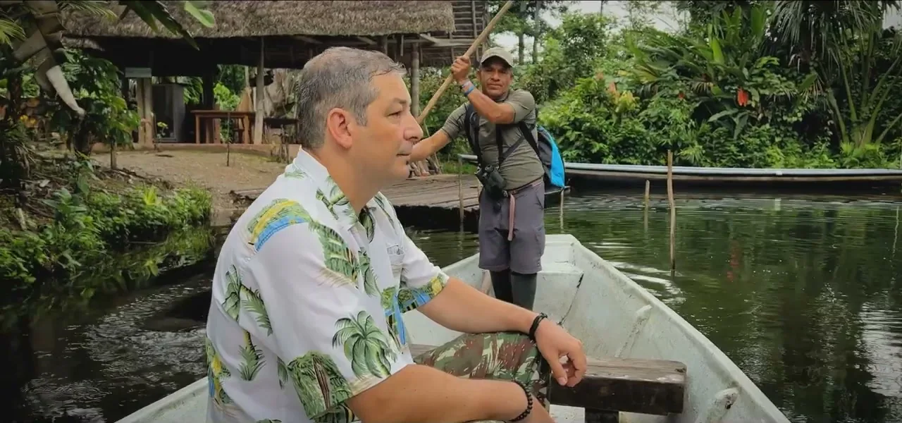 Sorin on a small boat on an Amazon river with a local guide