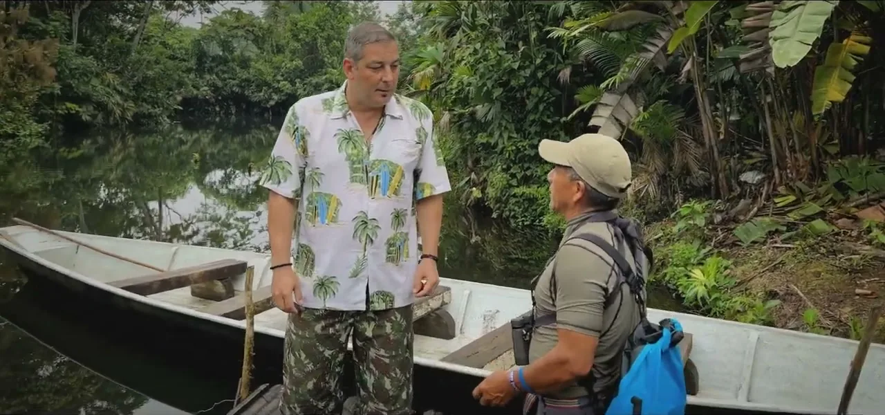 Sorin and a guide in a dugout canoe on a river in the Ecuadorian Amazon