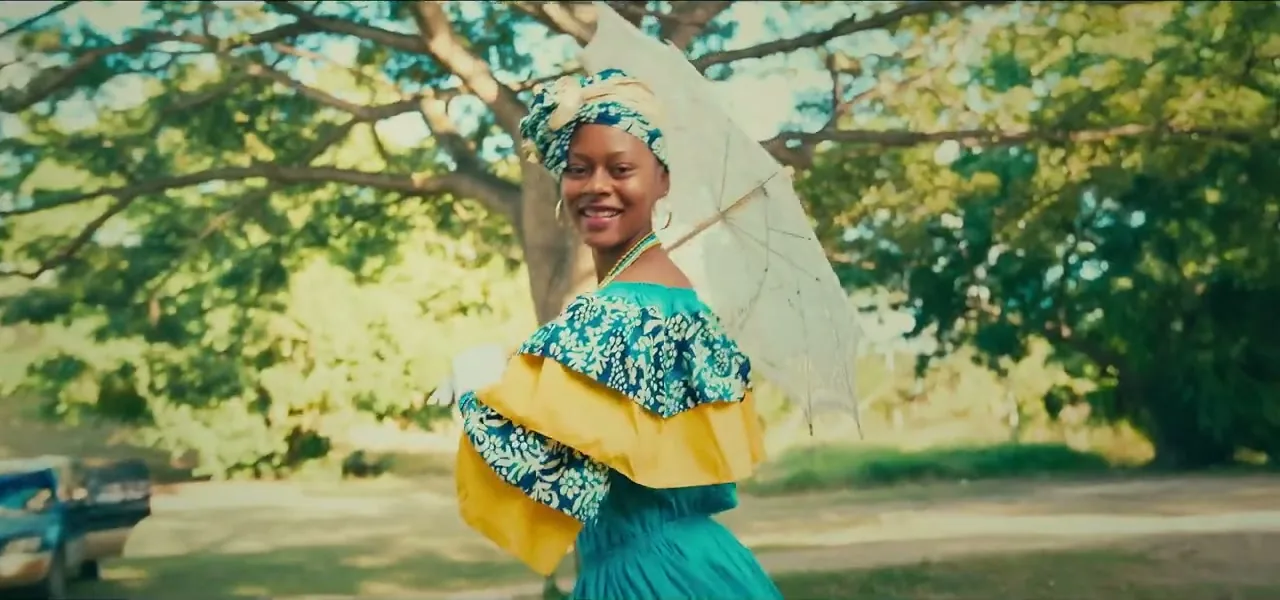 A performer in a colourful moko jumbie carnival costume in Antigua
