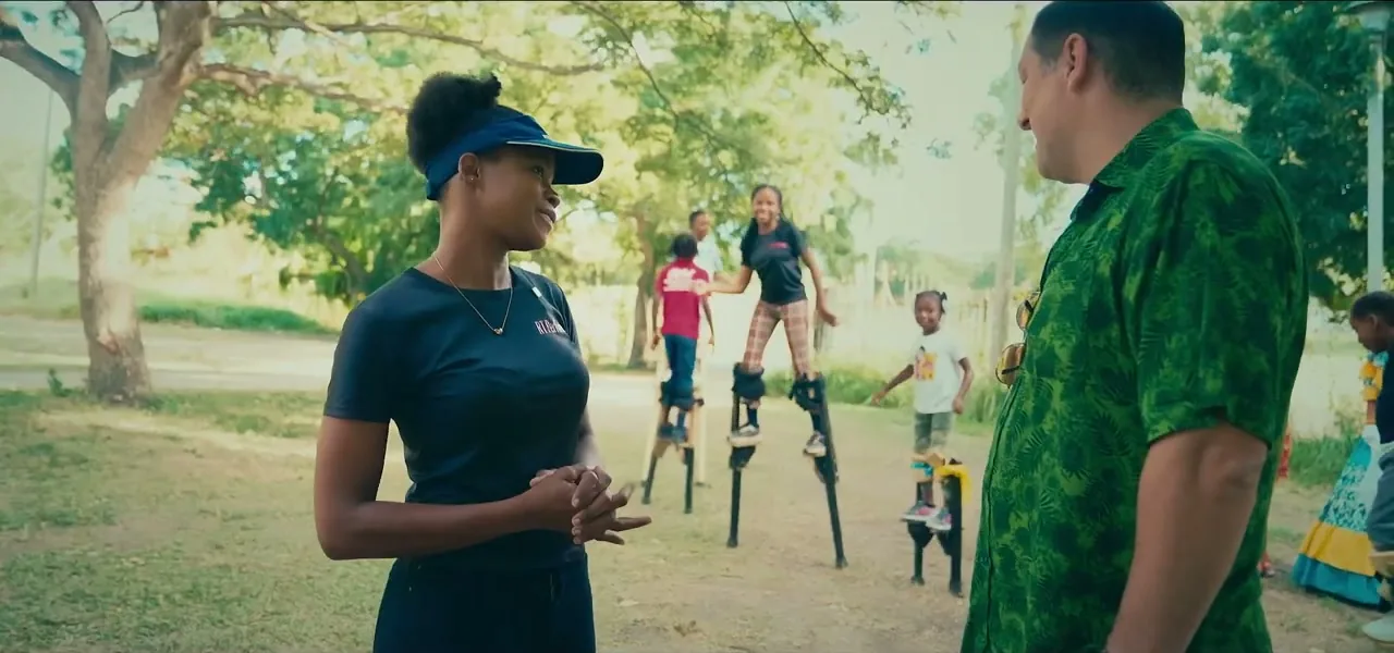 Children learning to walk on stilts with an instructor in Antigua