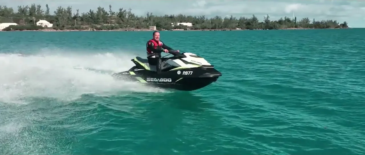 Sorin riding a jet ski across turquoise water inside the Bermuda Triangle