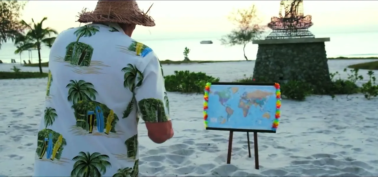 Sorin about to throw a dart at a world map on a beach in Cambodia