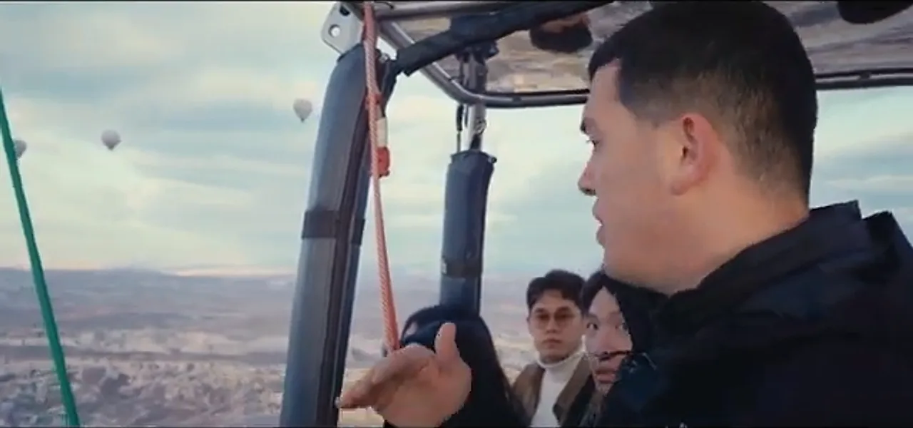 The view from inside a hot-air balloon over the Cappadocian landscape at dawn