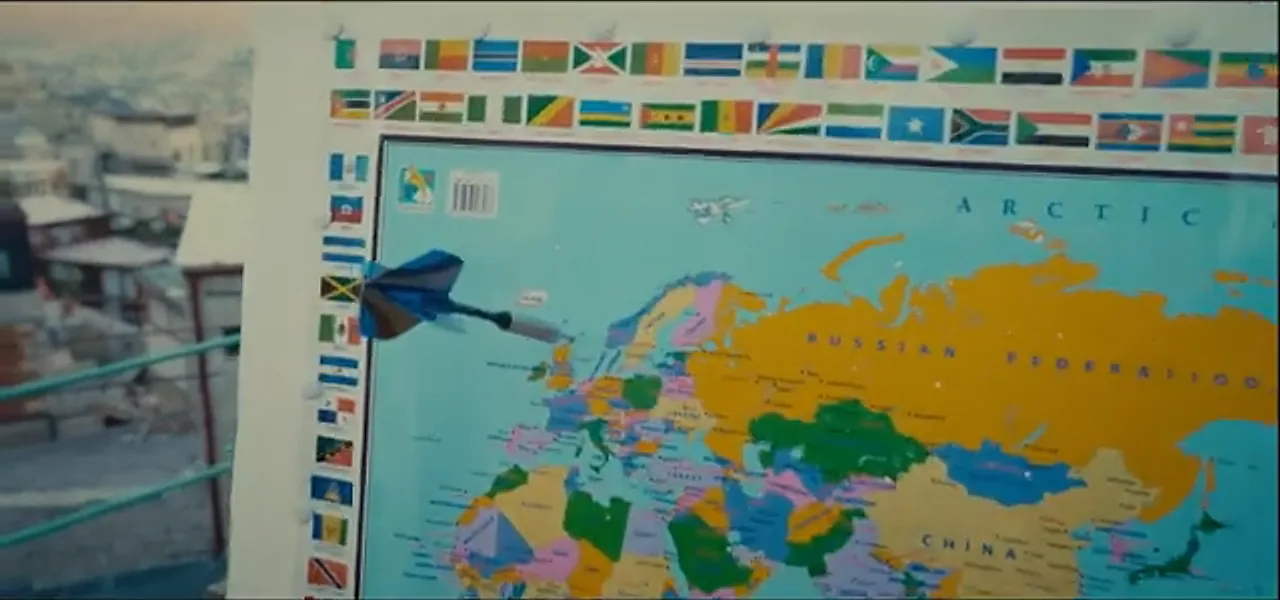 A dart landing at the top of the United Kingdom on a world map