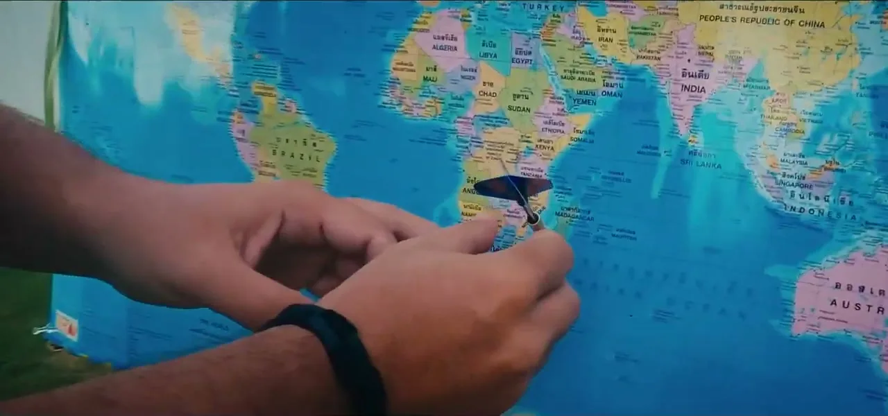 A dart landing near Japan on the world map during the Cayman Islands episode