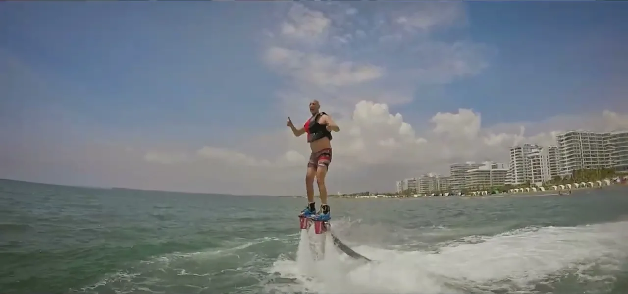 A person flyboarding, flying above the water off the coast of Cartagena, Colombia