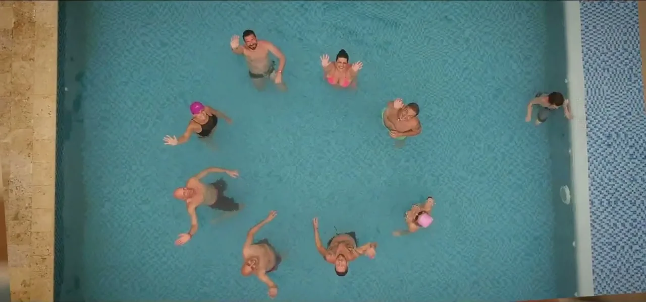 Aerial view of the group floating in turquoise water off Tierra Bomba island, Colombia