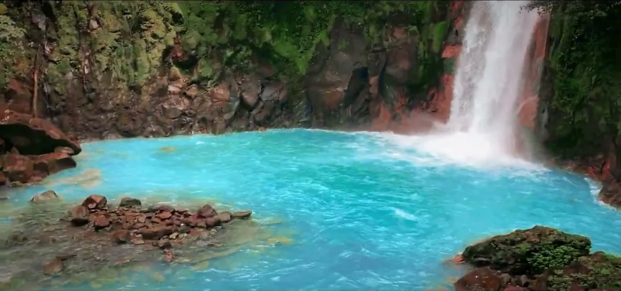 The vivid turquoise waterfall and pool of Rio Celeste in Tenorio Volcano National Park
