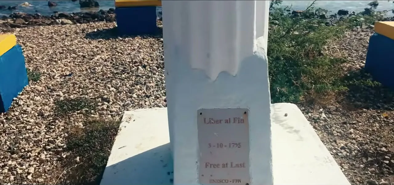 A monument marking the 1863 abolition of slavery in Curaçao, built on coral stone by the water
