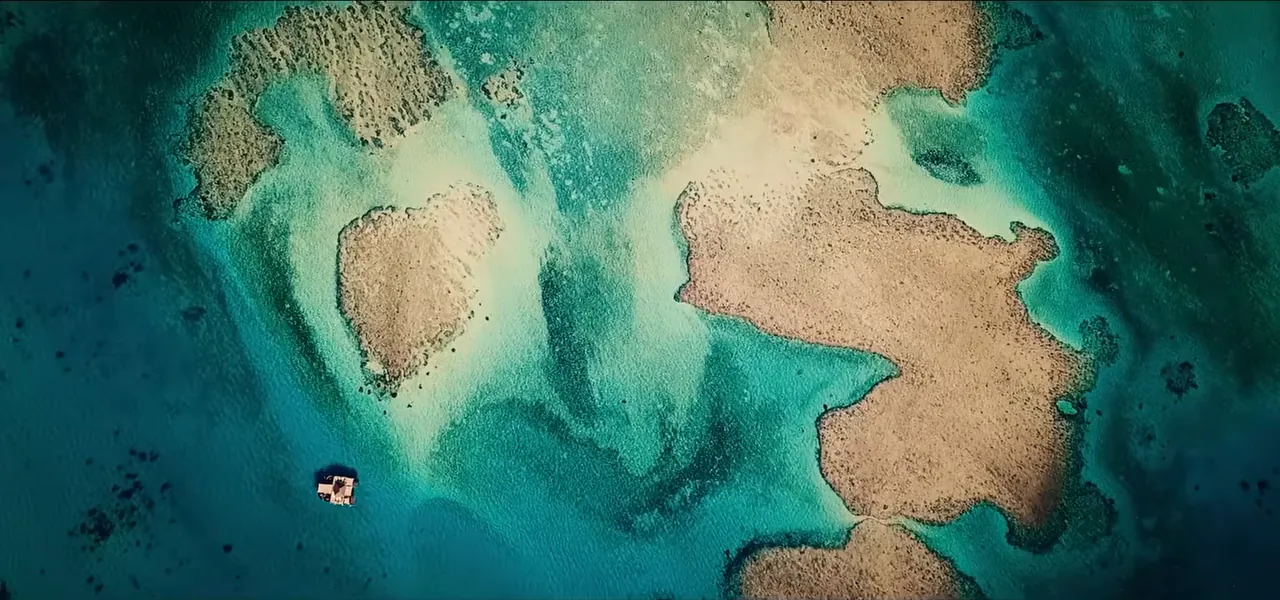 An aerial view of a small reef-ringed island in Fiji used as a film location