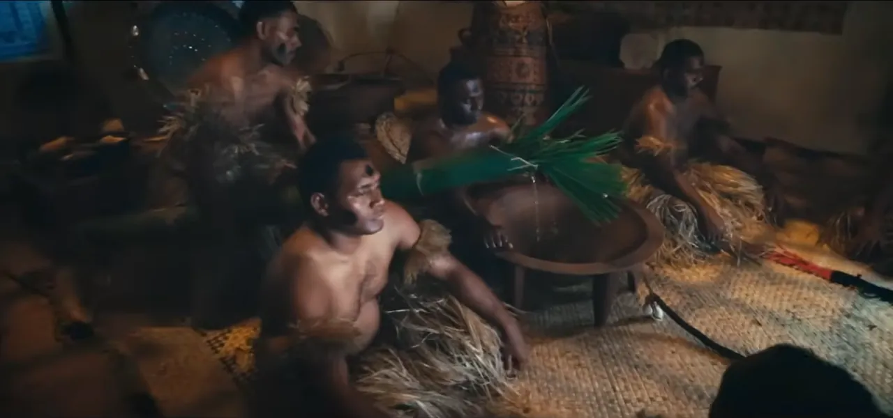 A Fijian kava (yaqona) ceremony with men seated around a wooden tanoa bowl