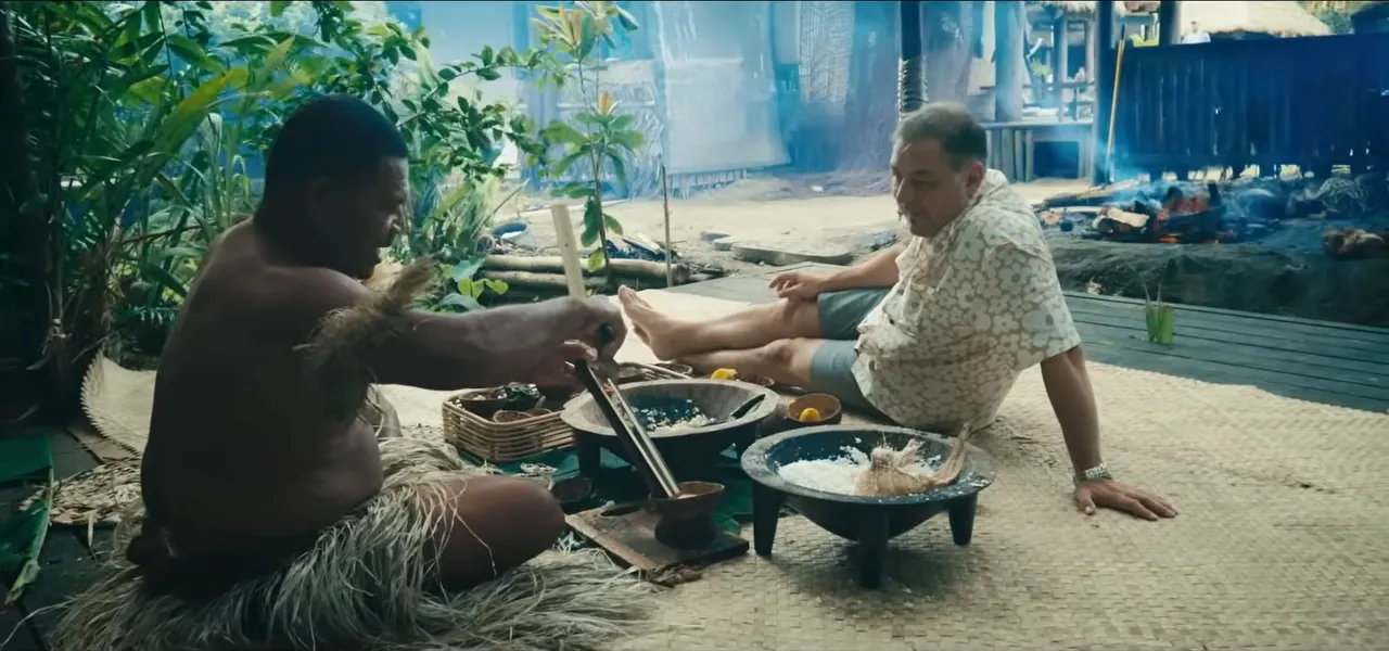 Sorin cooking traditional Fijian food on the ground with a local guide