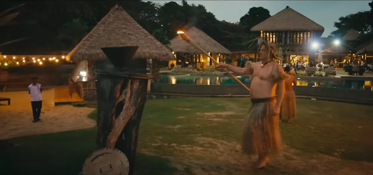A Fijian meke performance with dancers and torches at a resort at night