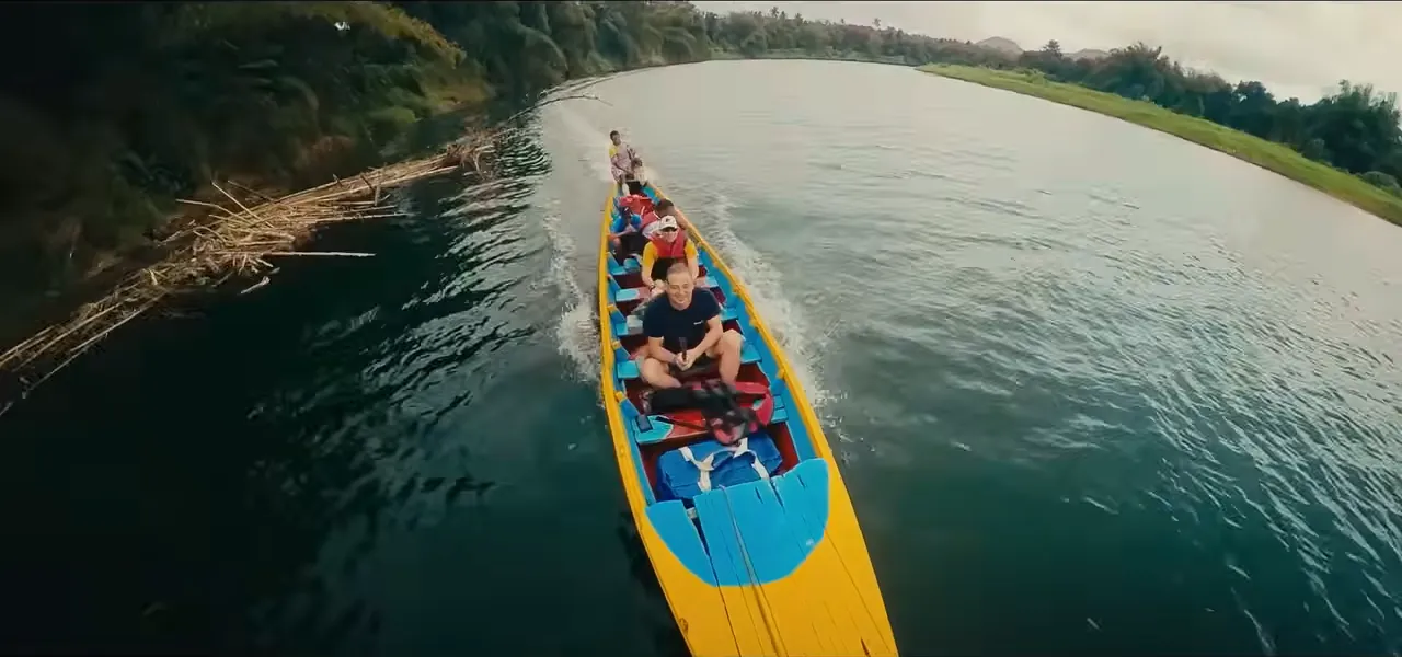 A long boat carrying passengers up the Navua River through the Fijian highlands