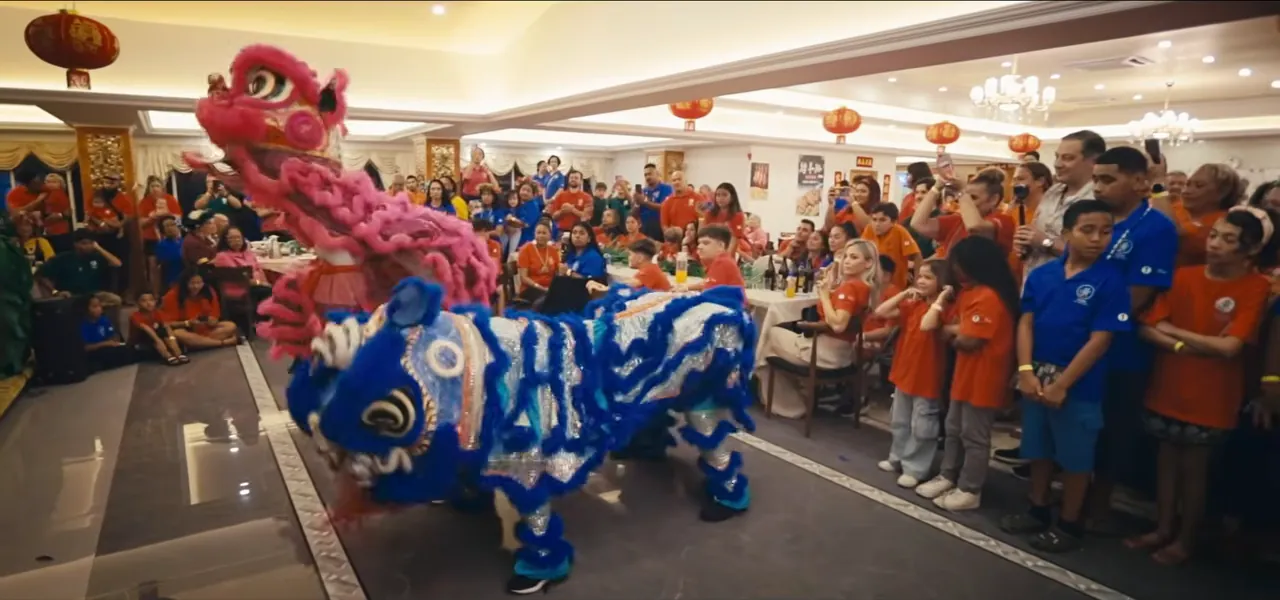 A large Fijian-Chinese family reunion with a lion dance in a banquet hall