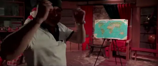 Sorin, blindfolded, throwing the dart at a world map on an easel in Santa's cabin