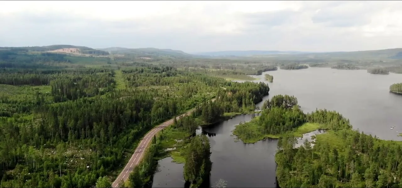 Aerial view of Finnish Lapland — endless forest, lakes and a lone road