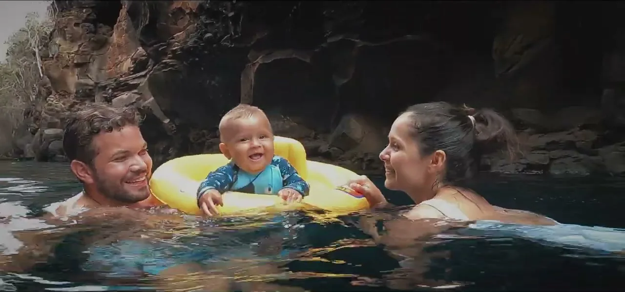 Sorin's friends and their young son in a pool in the Galápagos