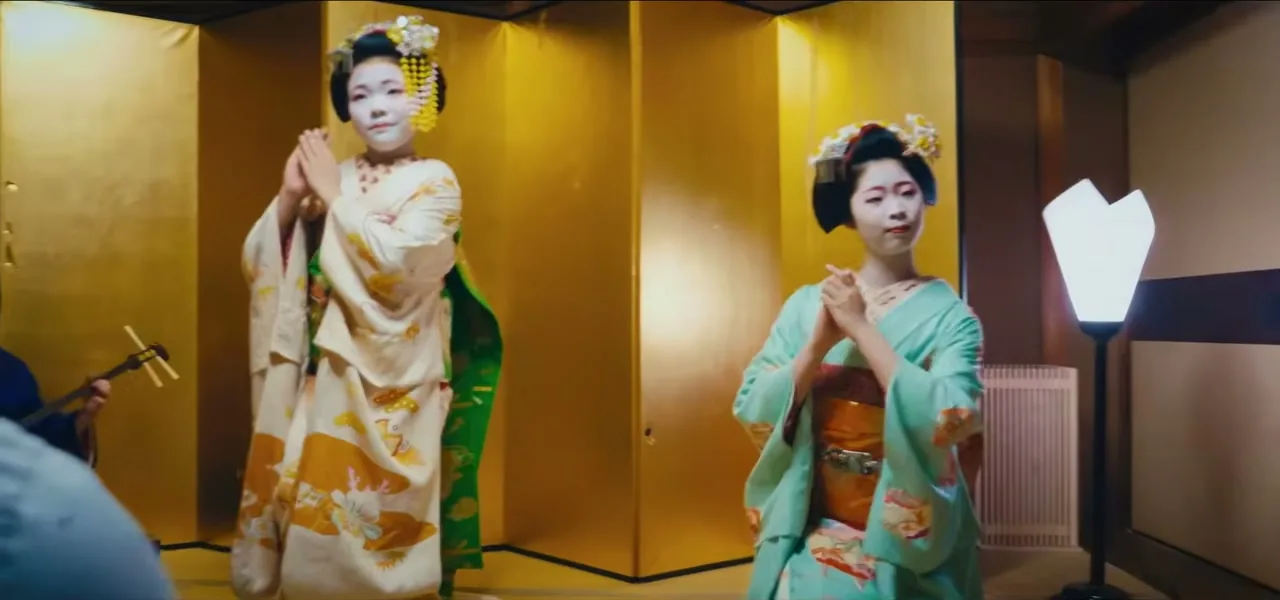 Maiko performing while a geiko provides music during a private ozashiki in Kyoto