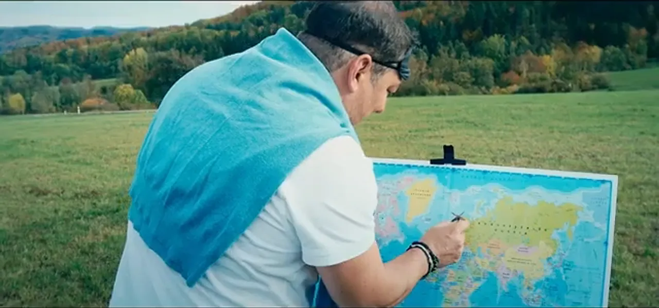 Sorin reading a world map after throwing a dart, at a castle in Germany