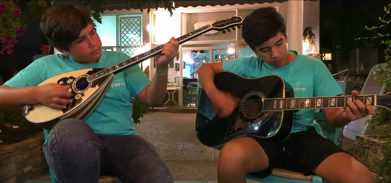 Two brothers playing bouzouki and guitar on Thassos island, Greece