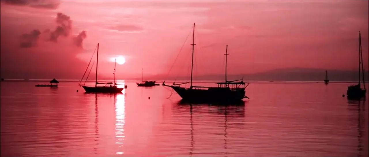 Traditional sailing boats silhouetted at sunset off Lombok, Indonesia