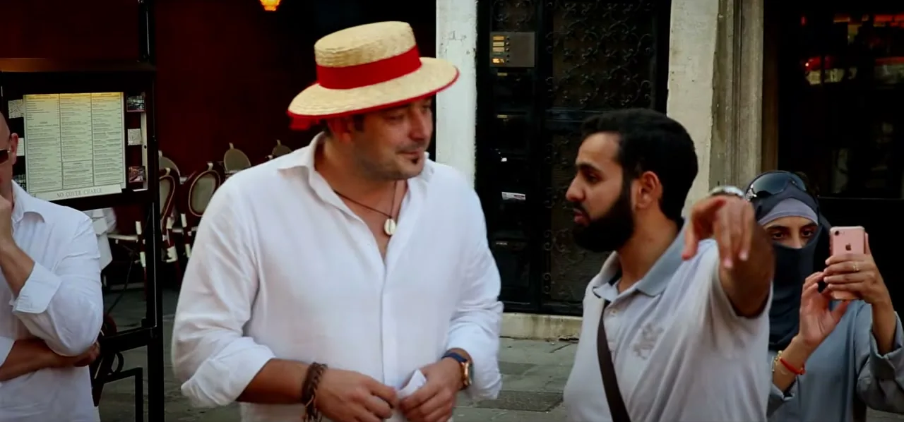 Sorin in a straw hat playing a gondolier in Venice, Italy