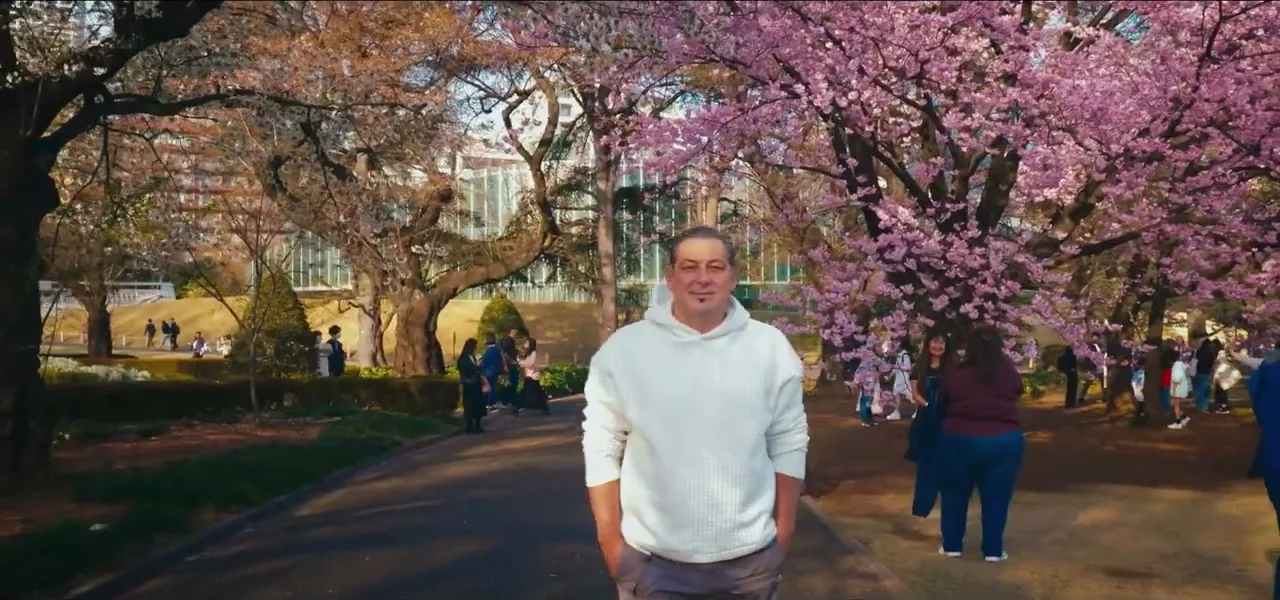 Sorin standing under blooming cherry blossoms in Tokyo, Japan