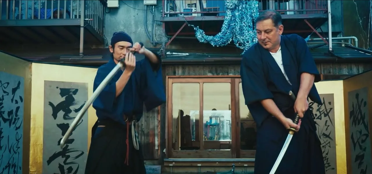 Sorin learning to handle a katana sword with a samurai instructor in Japan