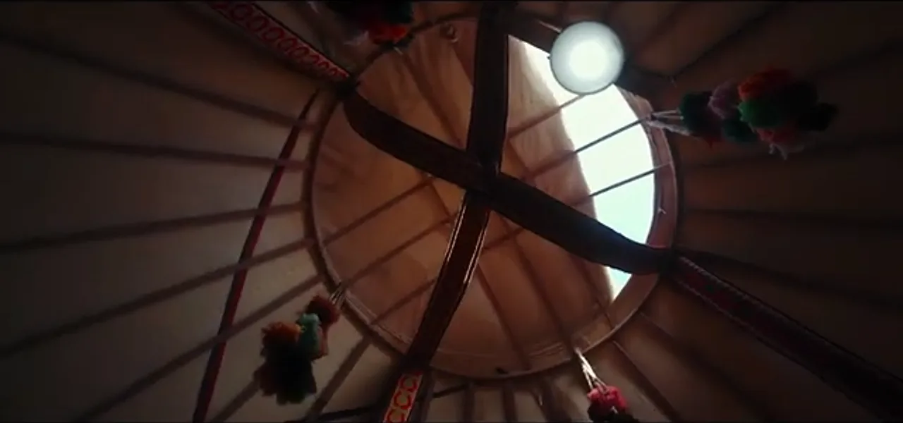 Looking up at the shangyrak, the wooden crown of a Kazakh yurt