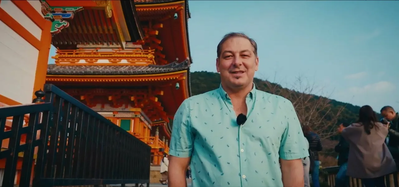 Sorin at Kiyomizu-dera temple, with the temple's vermilion architecture behind him, in Kyoto