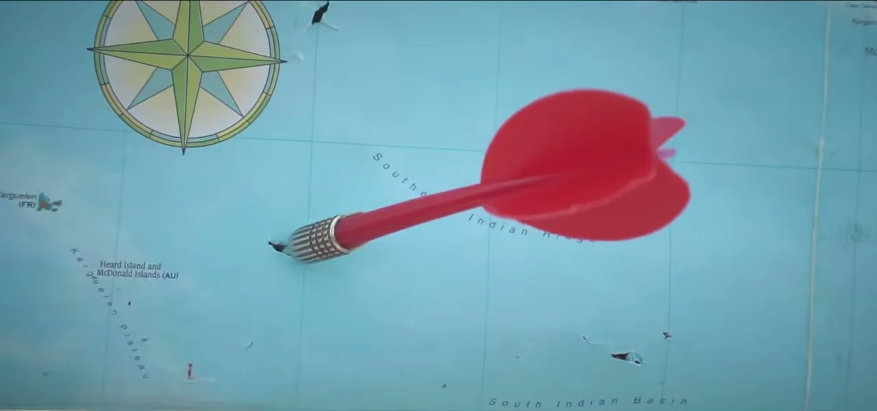 A red dart stuck in a world map during the dart-throwing ceremony in the Maldives