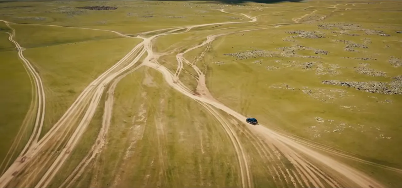 Faint dirt tracks branching in many directions across the empty Mongolian steppe