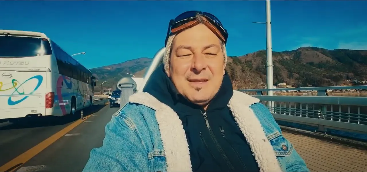 Sorin bundled up driving a small open electric car around Lake Kawaguchiko