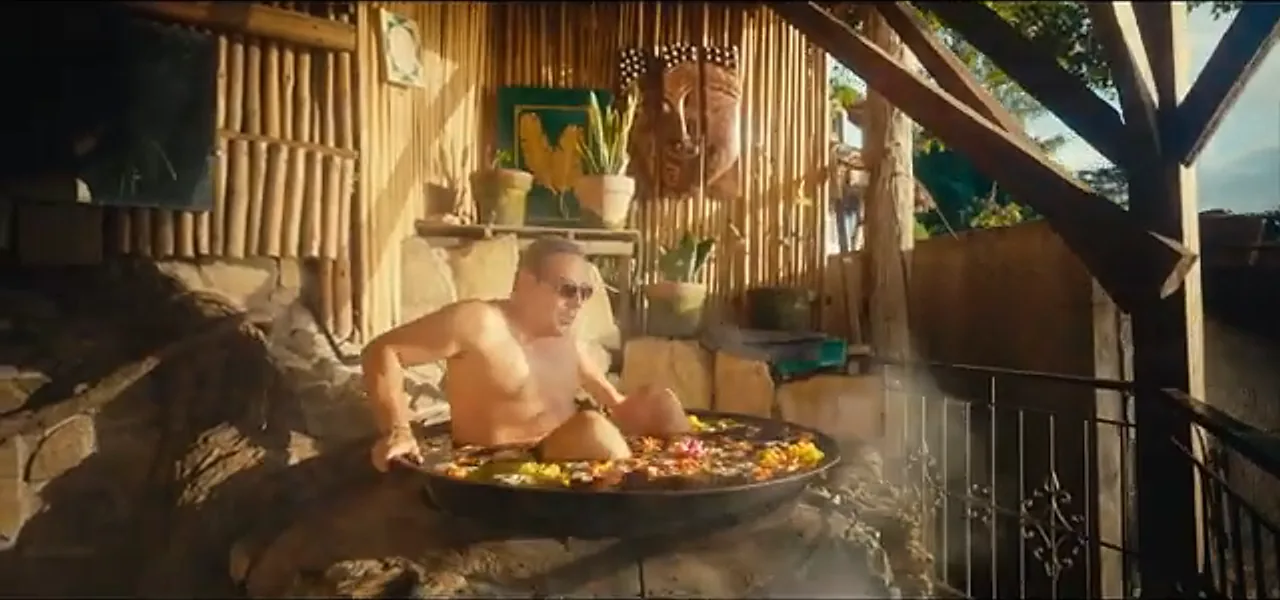 Sorin soaking in a kawa, a giant wok filled with flowers and water, at sunset in the Philippines
