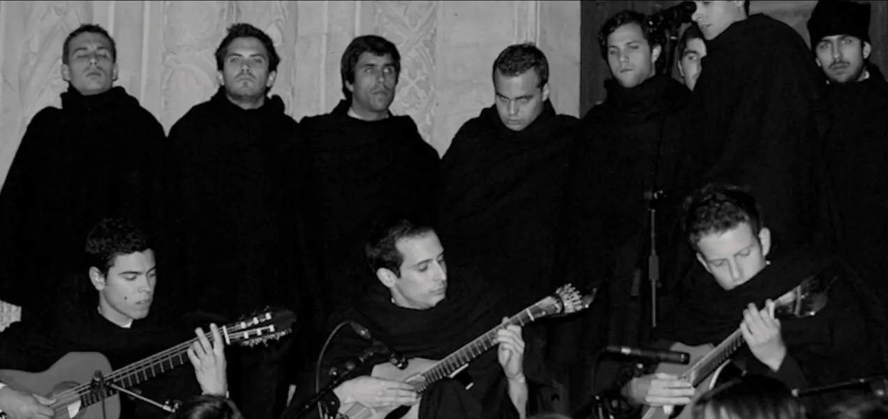 A historic black-and-white photograph of a Portuguese Fado ensemble with guitars