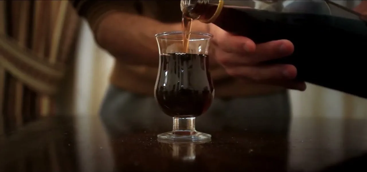 Ginjinha, a Portuguese sour-cherry liqueur, being poured into a glass