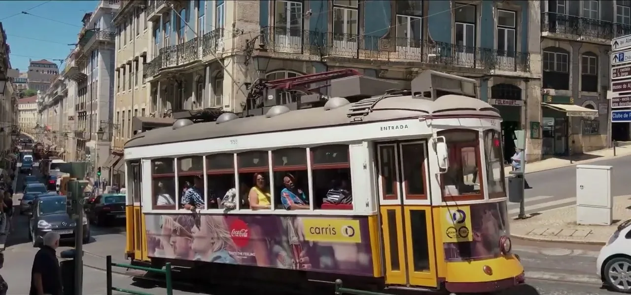 The vintage yellow Tram 28 on a street in Lisbon