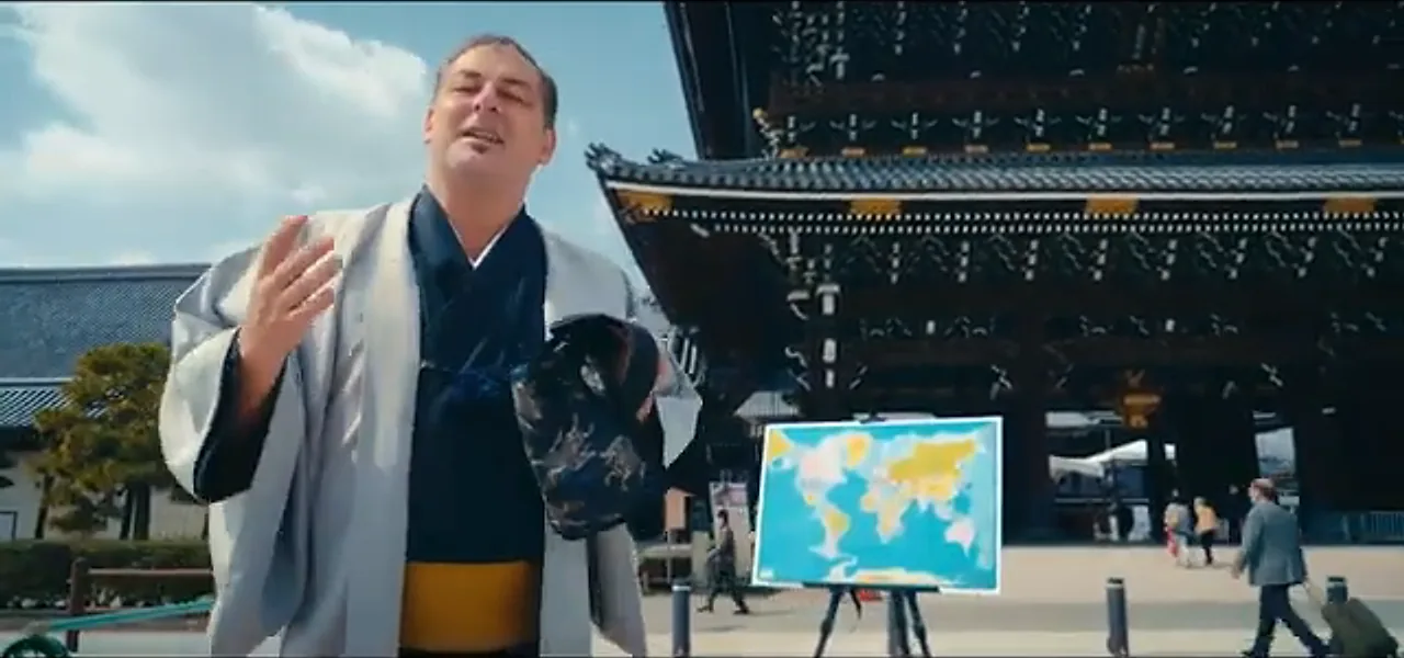 Sorin in a kimono throwing a dart at a world map at a temple in Kyoto, Japan