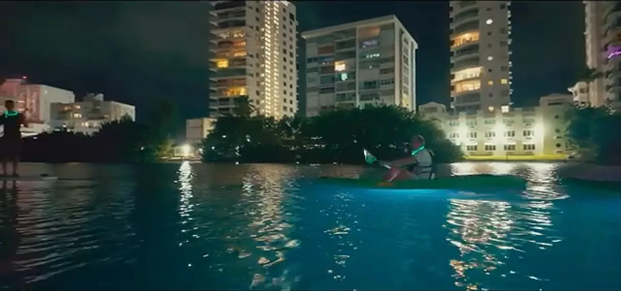 A neon-lit kayak on the Condado Lagoon at night in San Juan, Puerto Rico