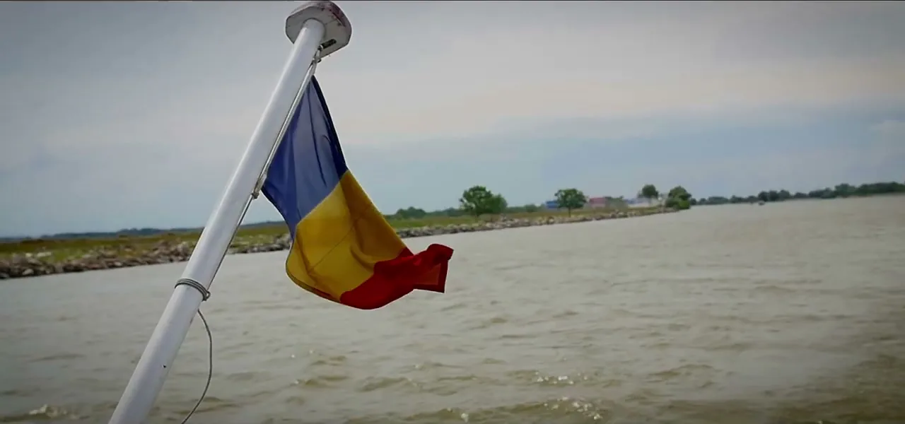 The Romanian flag on a boat crossing the Danube Delta, Romania