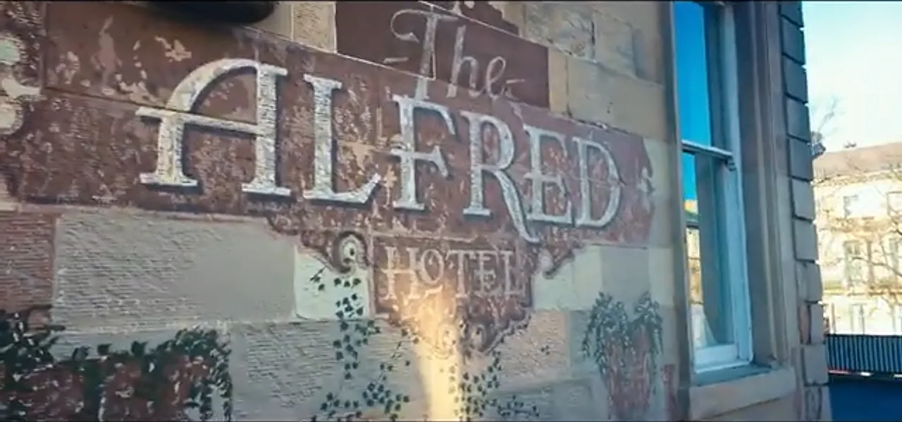 The weathered sign of The Alfred Hotel in Glasgow, Scotland