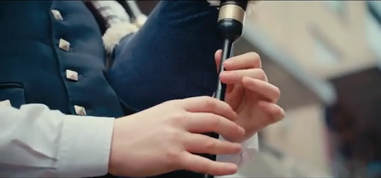 Close-up of hands on the chanter of a set of Scottish bagpipes