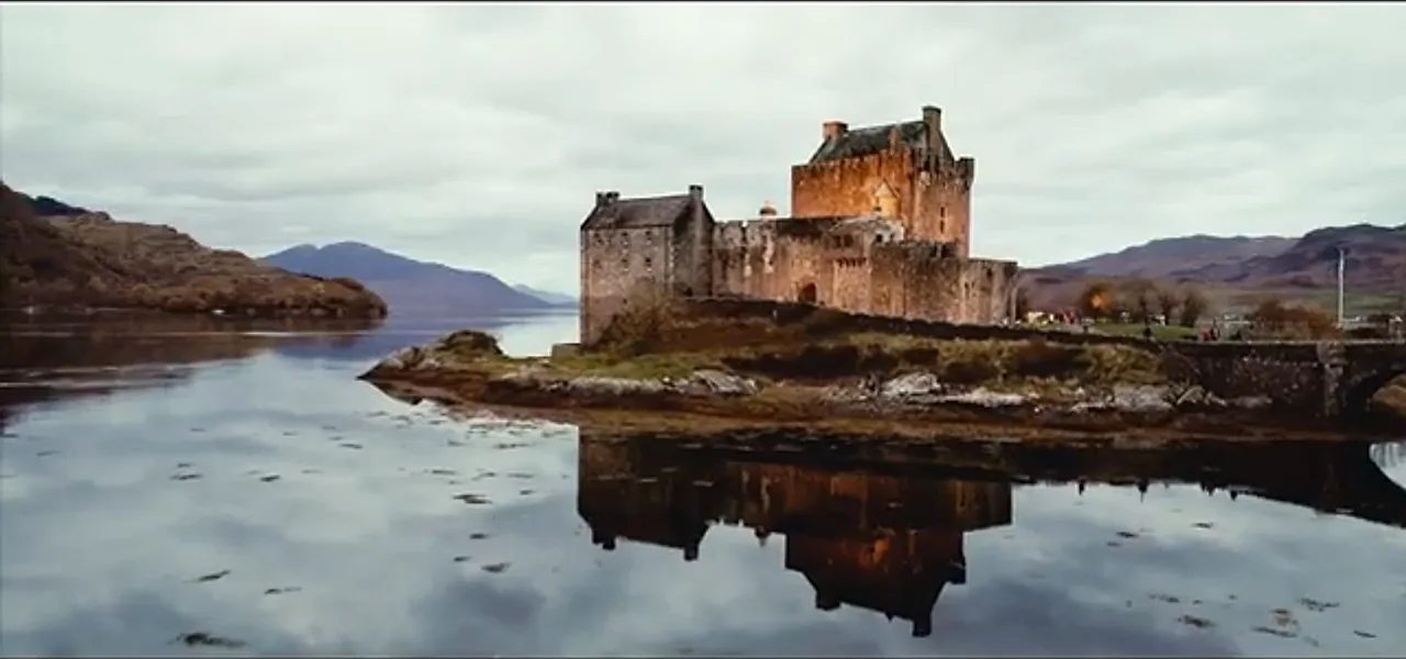 Eilean Donan Castle on its island, reflected in a still Highland loch