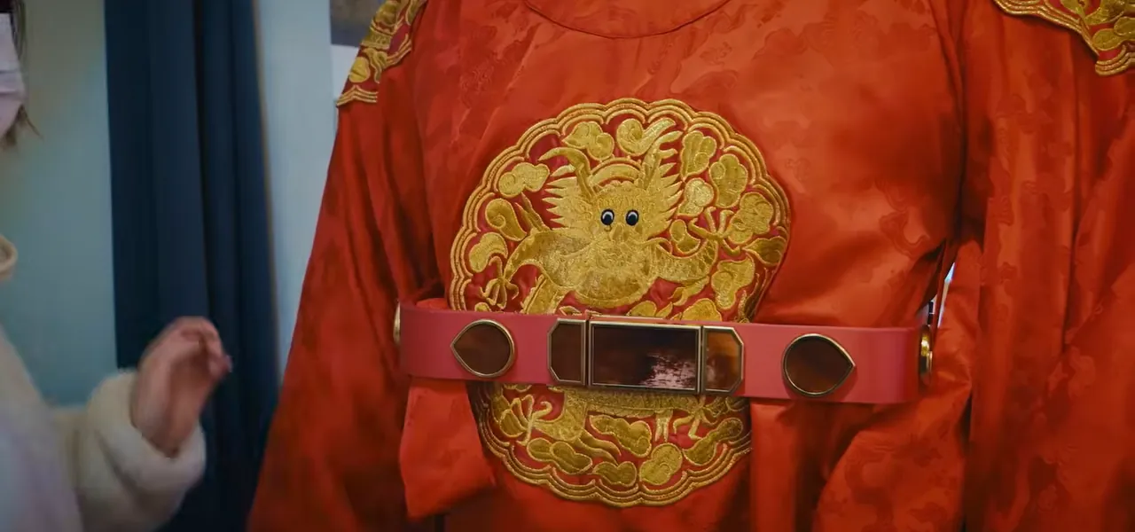 A red Korean king's hanbok robe with a gold dragon emblem