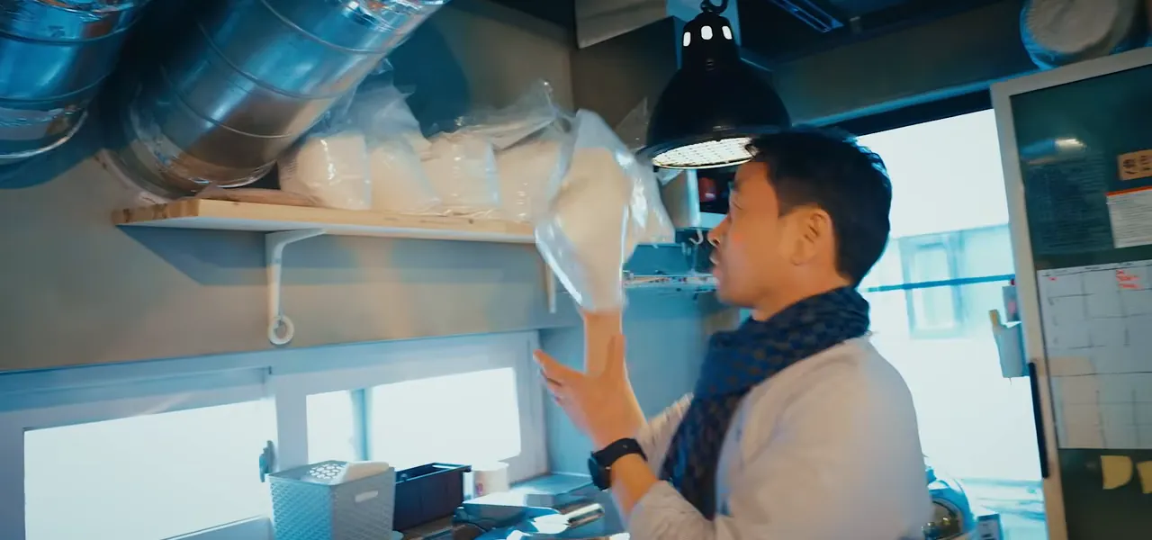 A brewer straining fresh makgeolli rice wine at his brewery in Seoul