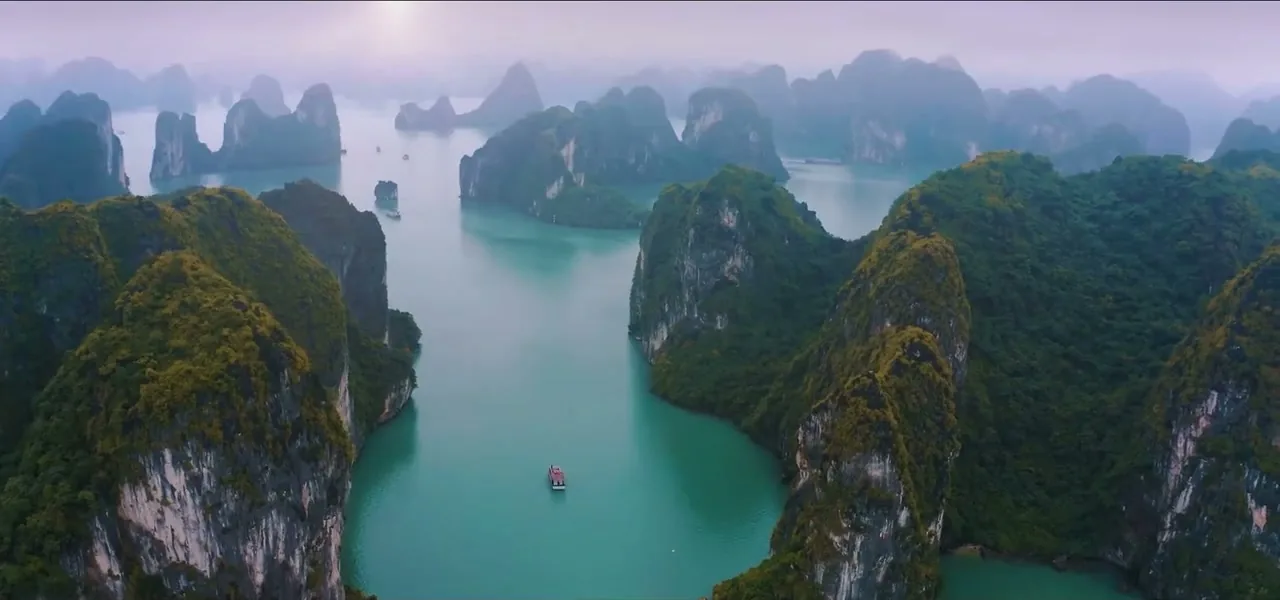 Limestone karst islands rising out of the emerald water of Halong Bay, Vietnam