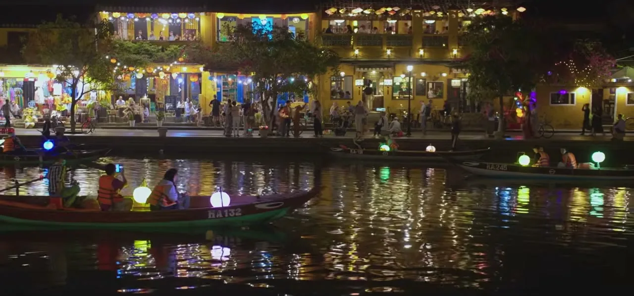 Colourful lanterns reflected in the river at night in the ancient town of Hoi An, Vietnam