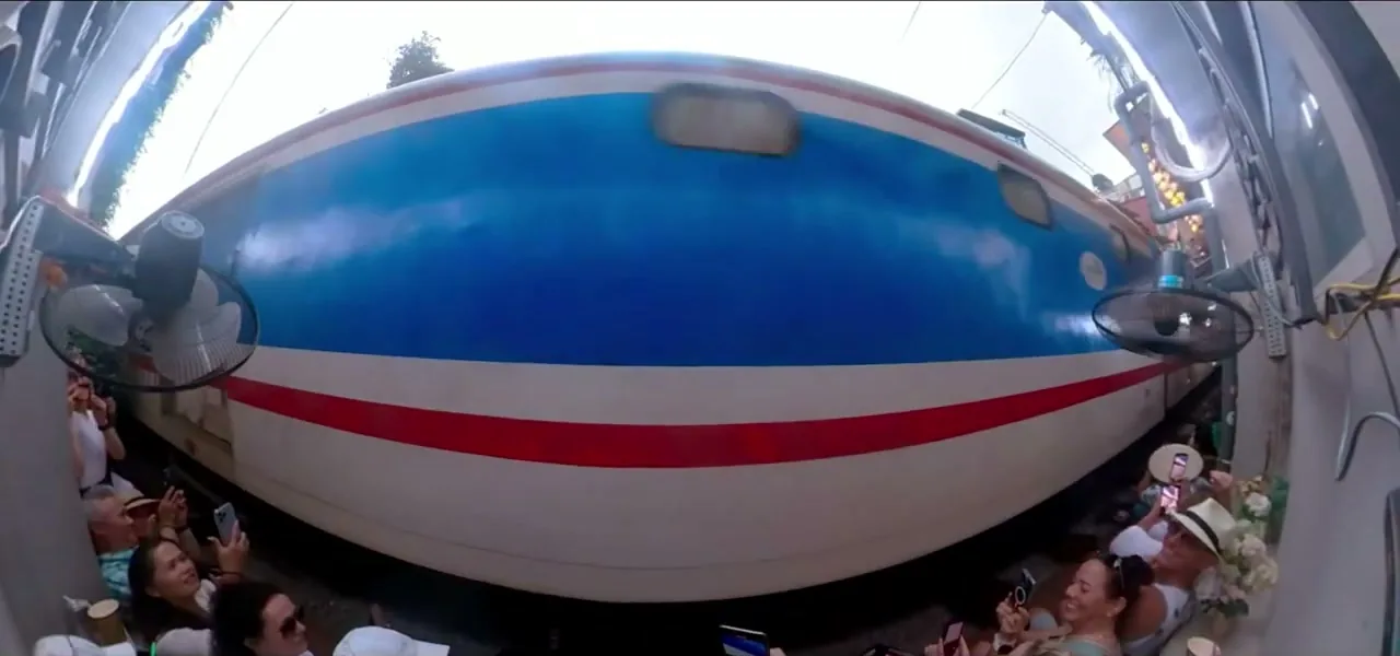 A train passing within inches of houses and cafes on Hanoi Train Street, Vietnam
